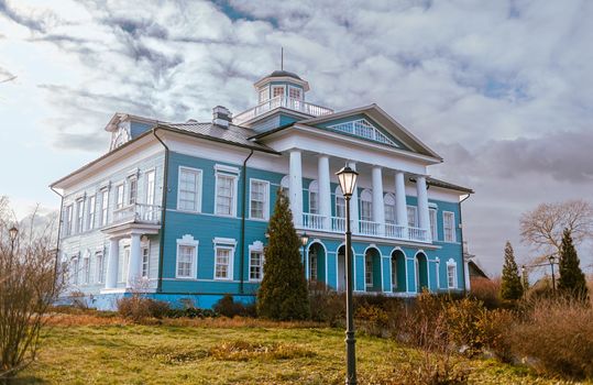 An old beautiful mansion with a wooden veranda, built in the 19th century. A big old house with a garden in Cherepovets, Russia. The building houses a museum 