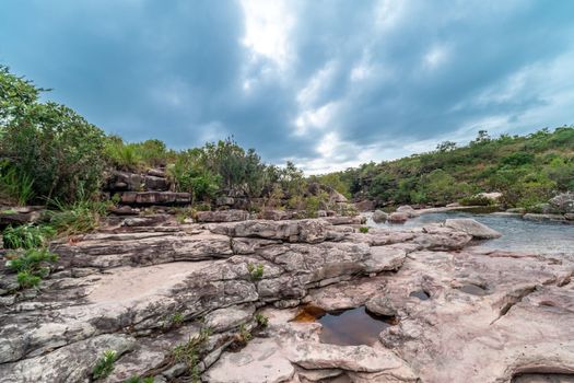 A mountain river flows through rocks in South America.