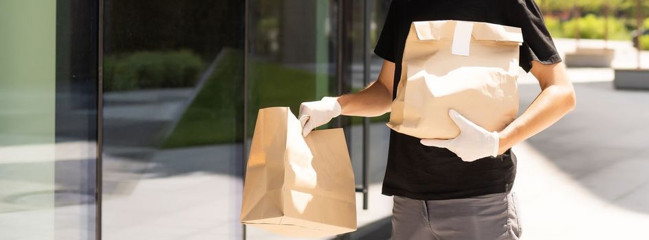 delivery guy in protective mask near the customer house, outdoors