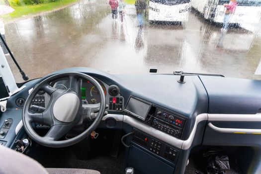 view of the dashboard and steering wheel of a tourist bus in the parking lot. the cockpit of the bus. driver's workplace. Bus Driver's Console. Truck dashboard