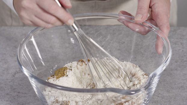 Step by step. Mixing ingredients in the glass mixing bowl to make pumpkin pancakes.