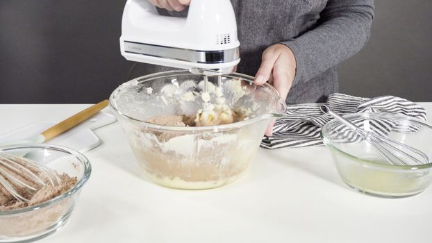Step by step. Mixing ingredients in a glass mixing bowl to bake chocolate cookies.