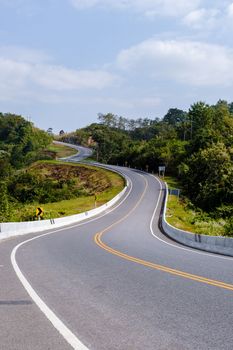 Curved road in the mountains of Nan Thailand, Road nr 3country road rear view. Number three of the road among the mountains at Nan, Thailand. couple man and women on vacation in Nan Thailand.