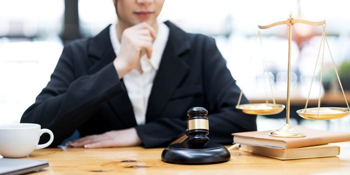 Judge gavel with Justice lawyers, Business woam in suit or lawyer working on a documents. Legal law, advice and justice concept..
