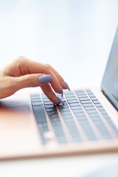 Purchases via the Internet and payment for services buy credit card. Hands type text and enter data on the laptop keyboard. An office worker checks his email while sitting at his desk