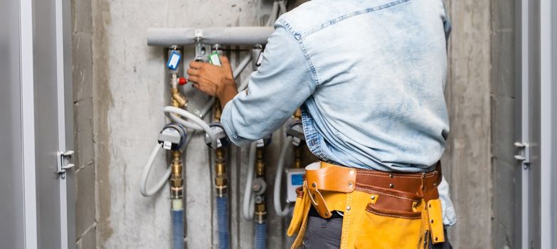 Plumber Repairing Water Pipes In Residential Building.