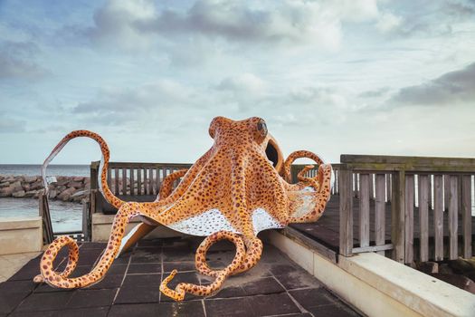 Huge decorative octopus on the playground in a Danish port city Grenaa Havn.