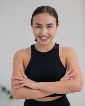 Portrait of a beautiful Asian woman with crossed arms on her chest