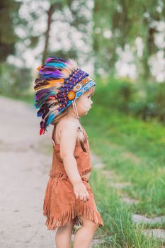 Cute baby dressed in traditional Native Americanс costume.