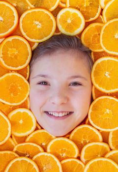 Portrait of beautiful smiling girl in oranges.