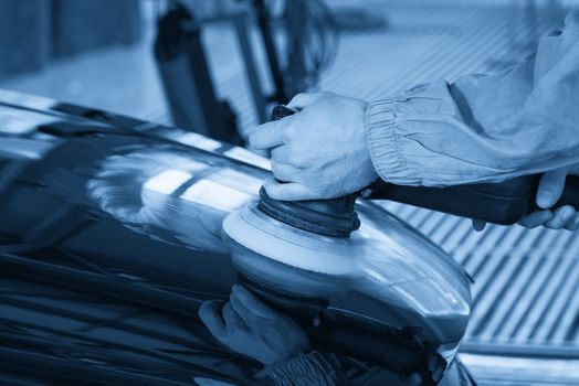 hands holding the work tool polish car, Auto Mechanic Polishing Car