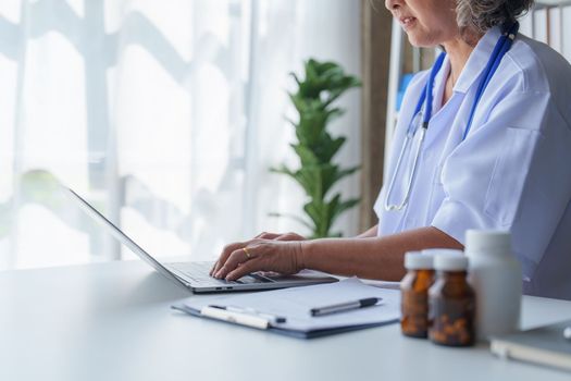 Doctor having conversation with patient while discussing explaining symptom and hold hand for encourage.