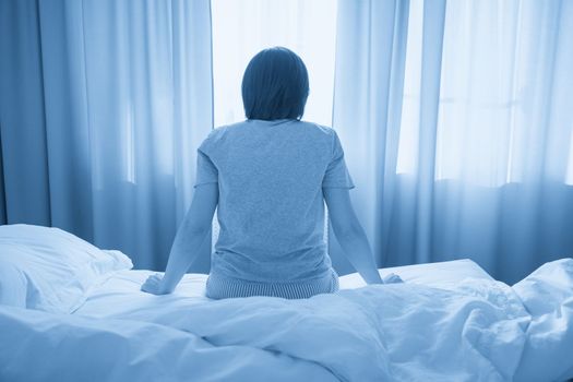 woman feel depression and sit on the bed