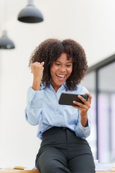 Business black woman having phone conversation with client in office. Woman reading news, report or email. Online problem, finance mistake, troubleshooting.