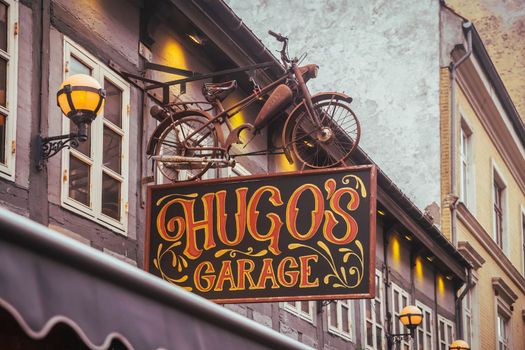 Aalborg, Denmark, October 2021: Bar with a vintage bike on the roof.