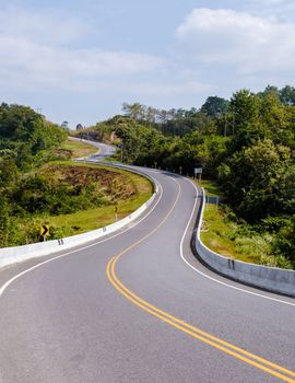 Curved road in the mountains of Nan Thailand, Road nr 3country road rear view. Number three of the road among the mountains at Nan, Thailand. couple man and women on vacation in Nan Thailand.