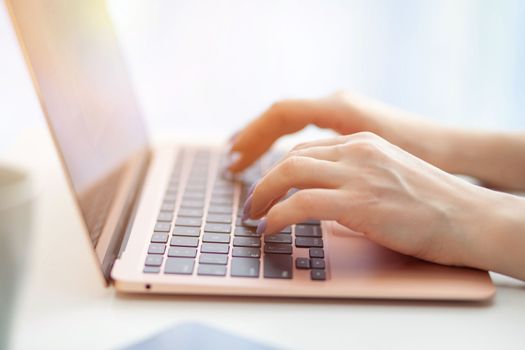 Purchases via the Internet and payment for services buy credit card. Hands type text and enter data on the laptop keyboard. An office worker checks his email while sitting at his desk