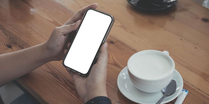 Close up of woman using cell phone,sending massages on the coffee shop.having sunbath.Phone with black screen,texting,video calls,..