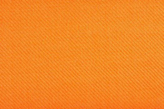 Texture of fabric for furniture upholstery. Wear-resistant fabric for furniture. Texture of orange fabric close up top view