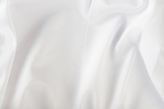 White wrinkled fabric. White fabric with large folds top view. For overlay texture or design