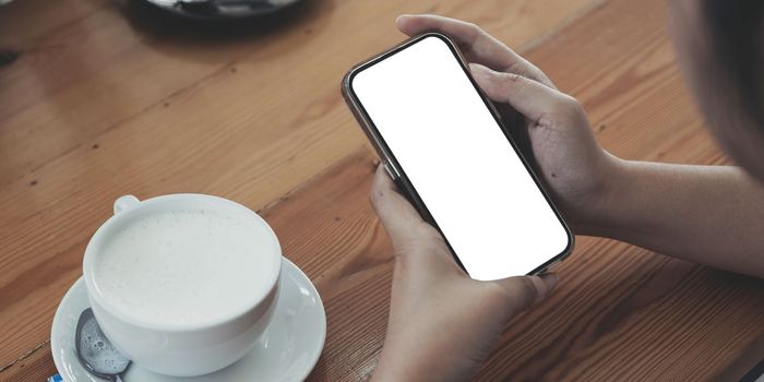 Close up of woman using cell phone,sending massages on the coffee shop.having sunbath.Phone with black screen,texting,video calls,..