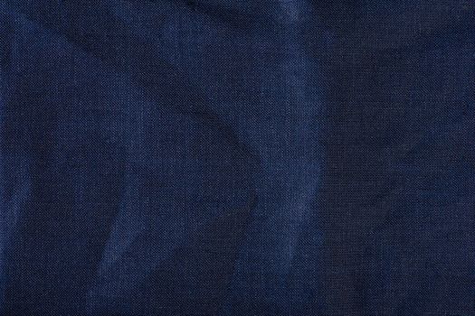 Texture of fabric for furniture upholstery. Wear and water resistant fabric in deep folds top view. Blue fabric texture closeup top view