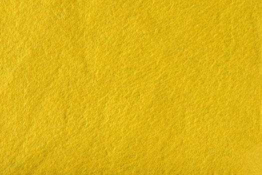 Texture of yellow felt. Abstract background with yellow felt. High resolution photo