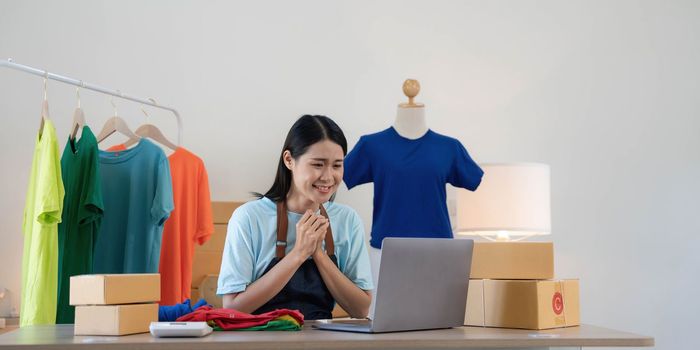 Young asian women happy after new order from customer. Surprise and shock face of asian woman success on making big sale of his online store. Online Selling.