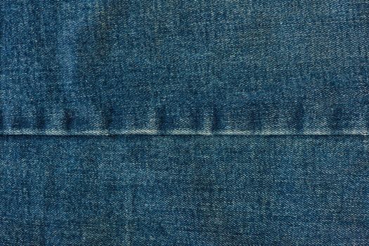 Texture of denim close-up. Jeans seam with place for text.