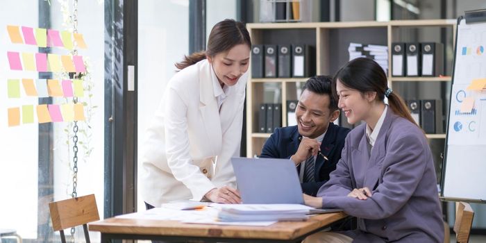 Group of young asian modern people in smart casual wear having a brainstorm meeting. Group of young asian business people discussing in the meeting...