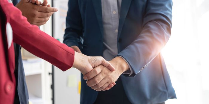 Business handshake for teamwork of business merger and acquisition,successful negotiate,hand shake,two businessman shake hand with partner to celebration partnership and business deal concept...