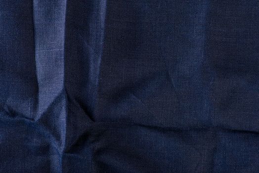 Texture of fabric for furniture upholstery. Wear and water resistant fabric in deep folds top view. Blue fabric texture closeup top view