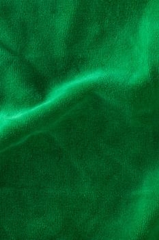 The texture of a microfiber cloth close-up. Napkins for cleaning and cleaning green surfaces. Washable