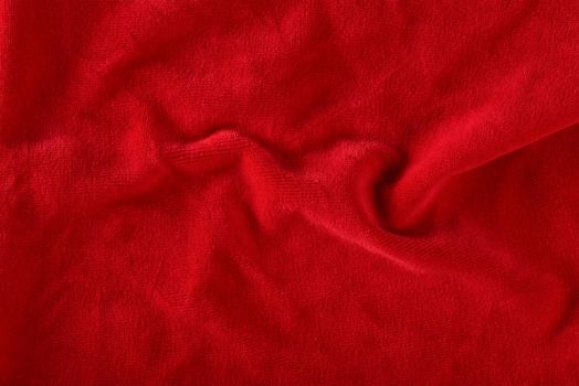 Red velvet texture for postcard or background for design. Red background for Christmas theme or Valentine's day, high quality, large format. Abstract texture of draped red velvet.