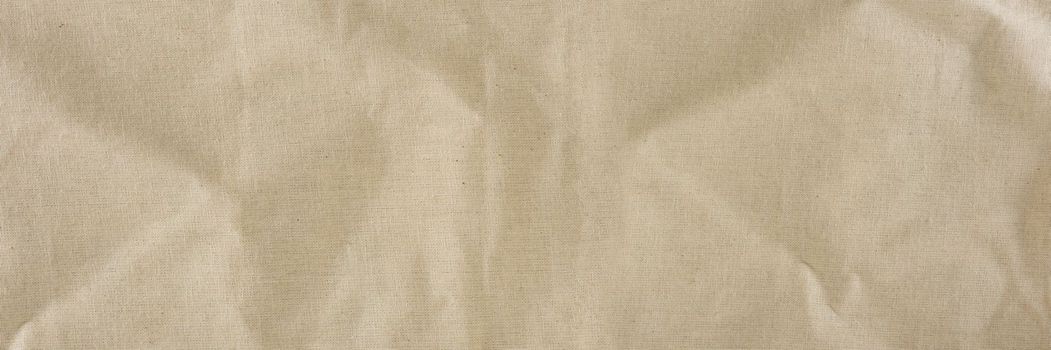 Texture of linen fabric in natural yellow color. The surface of the linen fabric as a background or banner, close-up