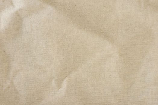 Texture of linen fabric in natural yellow color. The surface of the linen fabric as a background or banner, close-up