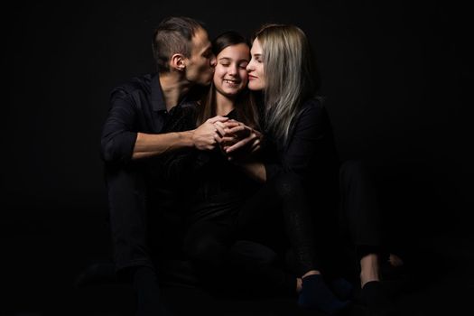 Family portrait on black background.