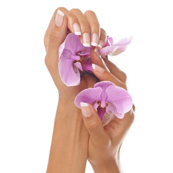 Woman hands, beauty and orchid flower with manicure nails after spa or beauty salon treatment in studio. Body of female model for floral background, health and wellness with natural cosmetics.