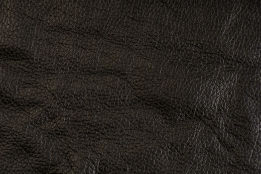 black leather texture, close-up of black genuine leather. Leather top view in folds and bumps