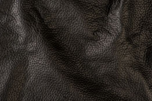 black leather texture, close-up of black genuine leather. Leather top view in folds and bumps