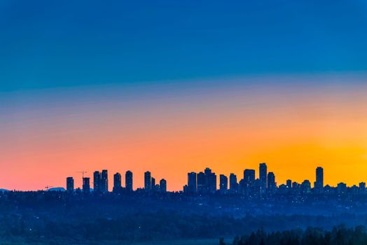 Metrotown district on sunset sky background.