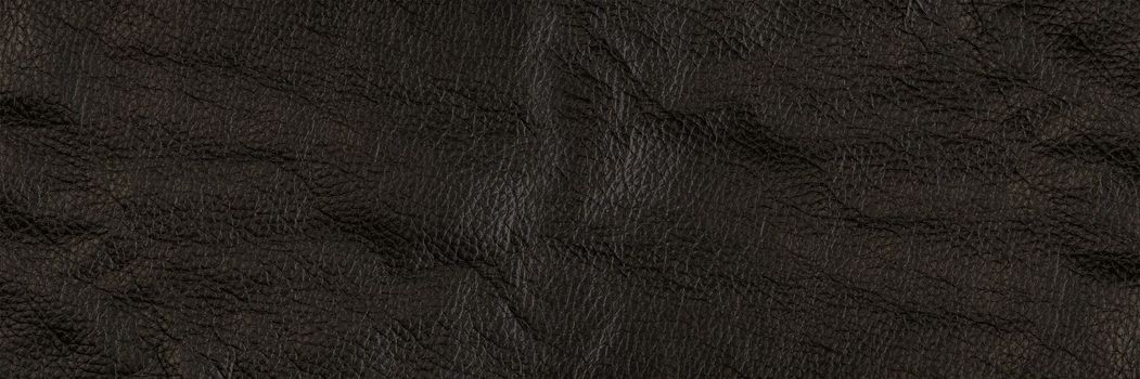 black leather texture, close-up of black genuine leather. Leather top view in folds and bumps