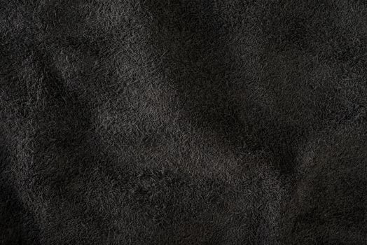 Black suede close-up. Natural black suede texture for design or project. Velvet, leather reverse