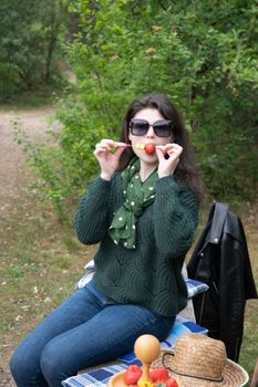 young beautiful brunette woman eat strawberry dessert at picnic on the bench High quality photo