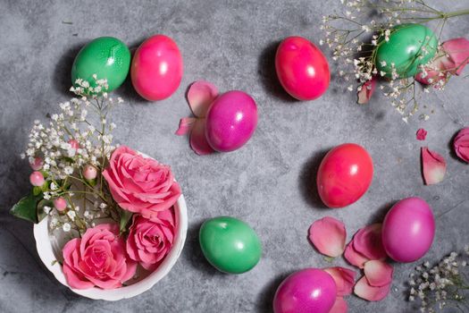 colorful easter eggs scattered on gray concrete background, top view, High quality photo
