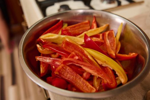 Selective focus on chopped raw sweet and colorful bell peppers on metal bowl. Healthy food. Canning vegetables. Preserving for the winter. Step-by-step conserving harvested crop of organic vegetables