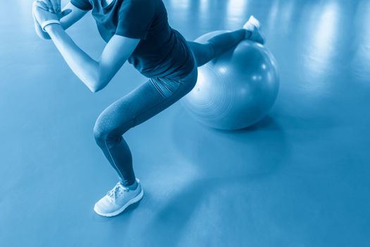 Woman at the gym with a pilates ball