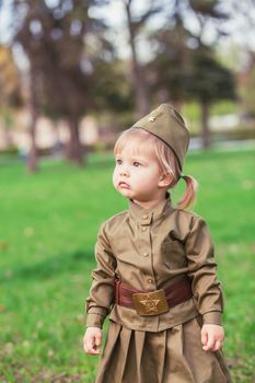 Adorable baby girl in Soviet military uniform.