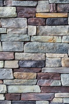 Decorative brown and grey colored stone setting. Cut stone wall texture