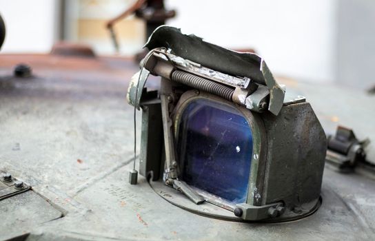 Detail of an old Russian tank, destroyed viewfinder. Destroyed tank, infantry vehicle. Thermal imaging night sight rangefinder. Prismatic viewing device for observing tanks and armored vehicles